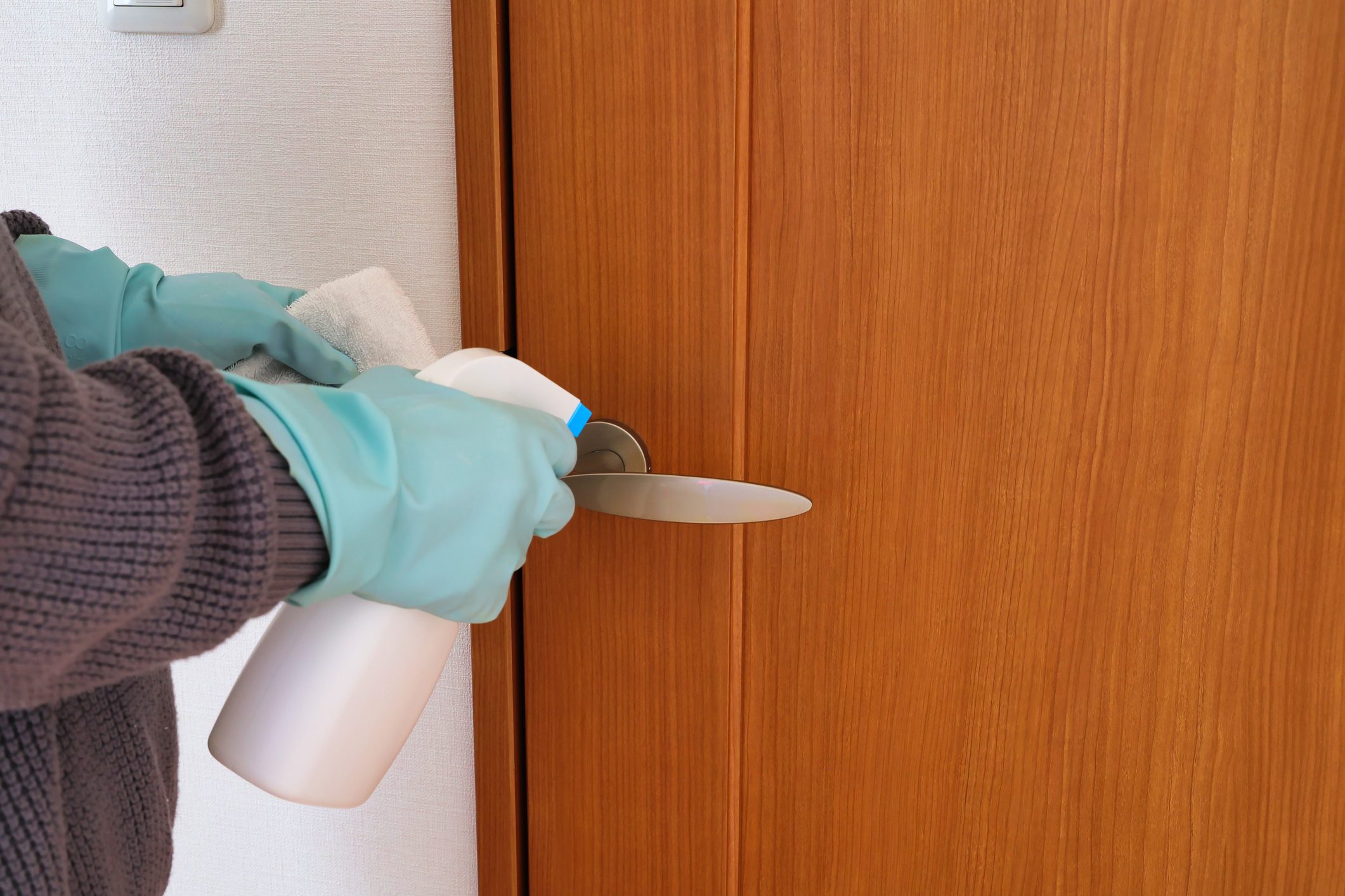 Alcohol disinfection image of doorknob using rubber gloves and spray